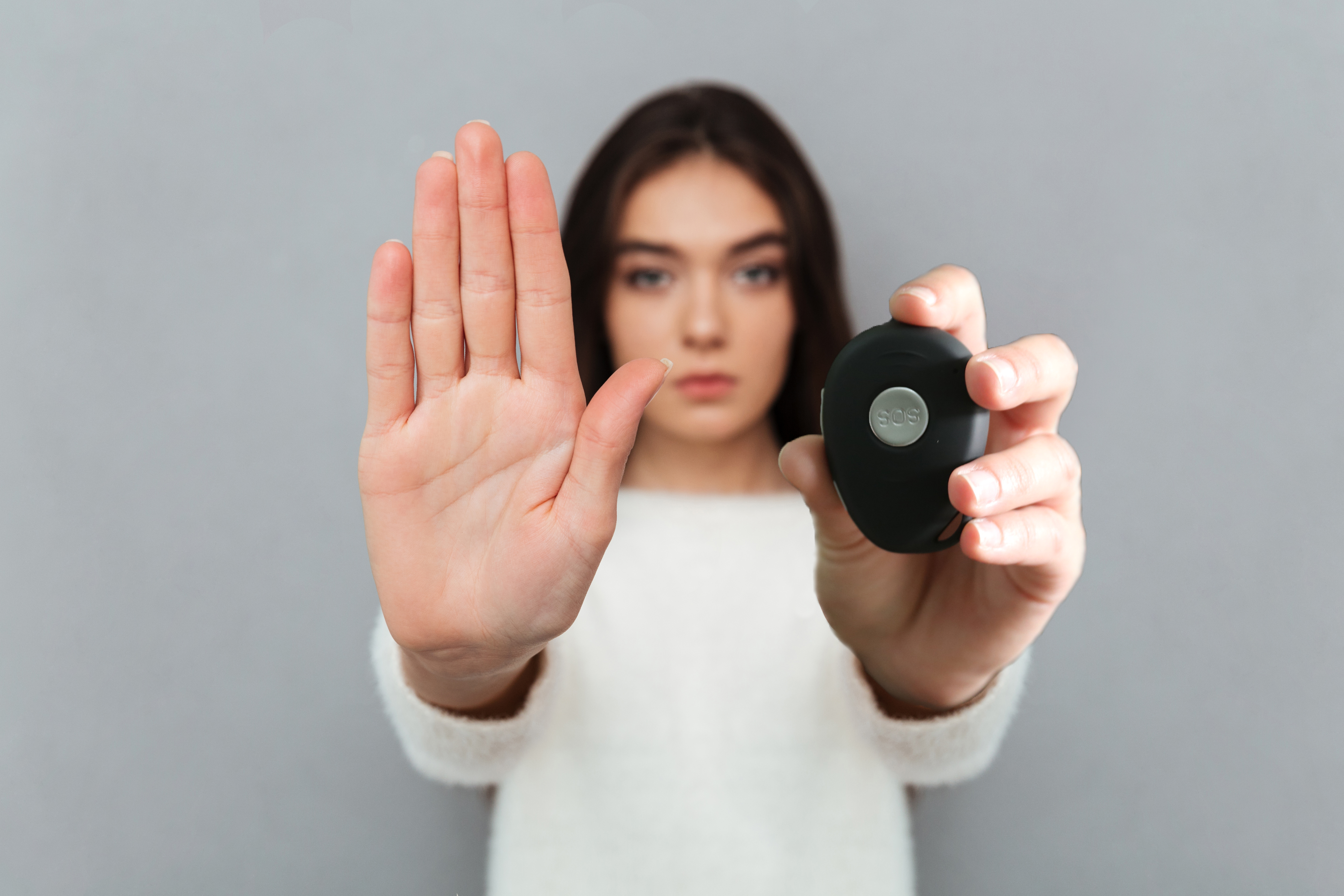 Close up portrait of a woman showing stop gesture