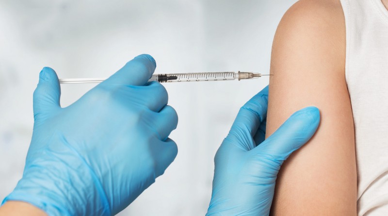 Close up of doctor's hands vaccinating child